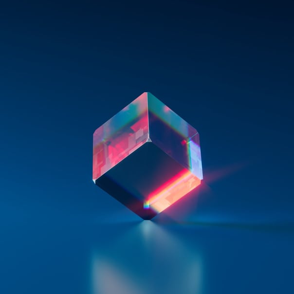 illustration of an ice-like cube with pink and blue internal reflections and inclined on a blue reflective background.
